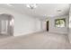 Spacious living room area with carpet floors, white walls, recessed lighting, and beautiful archways at 1550 S Chaparral Blvd, Gilbert, AZ 85296