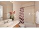 Well-lit bathroom with a modern sink, a decorative shower curtain, and coordinated fixtures for a fresh, clean feel at 16420 N Thompson Peak Pkwy # 2020, Scottsdale, AZ 85260