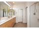 Bright bathroom with double sinks, a large mirror, a shower, and a separate doorway to the toilet at 16420 N Thompson Peak Pkwy # 2020, Scottsdale, AZ 85260
