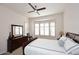 Bedroom featuring neutral decor, with a ceiling fan and bay window dressed with shutters to filter natural light at 16420 N Thompson Peak Pkwy # 2020, Scottsdale, AZ 85260
