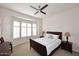 Comfortable bedroom with neutral decor, a ceiling fan, and a bay window dressed with white shutters at 16420 N Thompson Peak Pkwy # 2020, Scottsdale, AZ 85260