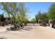 A neighborhood entrance gate featuring desert landscaping and wrought iron fencing at 16420 N Thompson Peak Pkwy # 2020, Scottsdale, AZ 85260