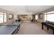 An indoor game room with a ping pong table, foosball table, and multiple tables and chairs at 16420 N Thompson Peak Pkwy # 2020, Scottsdale, AZ 85260