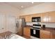 Bright kitchen featuring stainless steel appliances and wood cabinets providing storage space at 16420 N Thompson Peak Pkwy # 2020, Scottsdale, AZ 85260