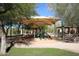 Shaded playground with various play structures and picnic tables for Gathering enjoyment at 16420 N Thompson Peak Pkwy # 2020, Scottsdale, AZ 85260