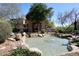 Water feature with rocks in a community area with lush landscaping and a barbeque at 16420 N Thompson Peak Pkwy # 2020, Scottsdale, AZ 85260