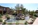 A water feature with rocks in a community area with lush landscaping at 16420 N Thompson Peak Pkwy # 2020, Scottsdale, AZ 85260