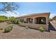 House exterior featuring desert landscaping, covered patios, and a tile roof at 16946 W Vernon Ave, Goodyear, AZ 85395