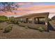 Covered patio with an outdoor living area, mature trees, and beautiful twilight sky at 16946 W Vernon Ave, Goodyear, AZ 85395