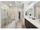 Spacious bathroom with walk-in shower, double sinks, and walk-in closet in the background at 16946 W Vernon Ave, Goodyear, AZ 85395