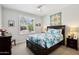 Bright bedroom with a ceiling fan, a large window, and a comfortable queen-sized bed at 16946 W Vernon Ave, Goodyear, AZ 85395