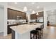 Modern kitchen with granite countertops, stainless steel appliances, and dark wood cabinetry at 16946 W Vernon Ave, Goodyear, AZ 85395