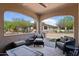 Inviting covered outdoor patio with comfortable seating and views of the landscaped backyard at 16946 W Vernon Ave, Goodyear, AZ 85395