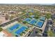 Aerial image featuring several blue tennis courts surrounded by mature landscaping at 16946 W Vernon Ave, Goodyear, AZ 85395