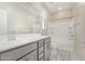 Clean bathroom with a single vanity, large mirror, and a shower-tub combination at 17736 W Cassia Way, Goodyear, AZ 85338