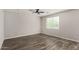 Neutral bedroom with hardwood floors, a ceiling fan, and a bright window at 17736 W Cassia Way, Goodyear, AZ 85338