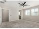Sunlit bedroom with a ceiling fan and views leading to the ensuite bathroom and kitchen at 17736 W Cassia Way, Goodyear, AZ 85338
