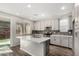 Bright kitchen with white cabinets, a central island, and modern appliances, perfect for cooking and entertaining at 17736 W Cassia Way, Goodyear, AZ 85338