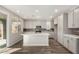 Modern kitchen featuring stainless steel appliances, a center island, and plentiful white cabinets at 17736 W Cassia Way, Goodyear, AZ 85338