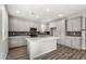 Modern kitchen features gray cabinets, a center island, stainless steel appliances, and stylish backsplash at 17736 W Cassia Way, Goodyear, AZ 85338