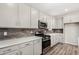 Well-equipped kitchen showcases stainless steel appliances and sleek white countertops at 17736 W Cassia Way, Goodyear, AZ 85338