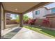 View of backyard featuring covered patio with concrete, rock features and a patch of lush artificial grass at 17736 W Cassia Way, Goodyear, AZ 85338
