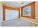 Well lit bedroom featuring plush carpet, closet with sliding doors, and an arched window with shutters at 17951 W Sammy Way, Surprise, AZ 85374