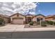 Beautiful single-Gathering home featuring a three-car garage and manicured desert landscaping at 17951 W Sammy Way, Surprise, AZ 85374