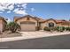 Single-Gathering home featuring a tile roof, three-car garage, and desert landscaping at 17951 W Sammy Way, Surprise, AZ 85374