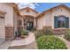 Charming home entrance with a walkway and mature desert landscaping at 17951 W Sammy Way, Surprise, AZ 85374