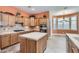 Bright kitchen with tile countertops, wooden cabinetry, and modern appliances at 17951 W Sammy Way, Surprise, AZ 85374