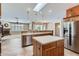 An open concept kitchen with a kitchen island, modern appliances, and tile flooring at 17951 W Sammy Way, Surprise, AZ 85374