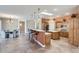 Open kitchen featuring wood cabinets, kitchen island, bar seating, and skylight providing natural light at 17951 W Sammy Way, Surprise, AZ 85374