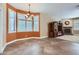 Bright living room with a fireplace, decorative chandelier, plantation shutters and view to the backyard at 17951 W Sammy Way, Surprise, AZ 85374