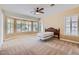 Expansive main bedroom with large windows offering plenty of natural light, and neutral carpet at 17951 W Sammy Way, Surprise, AZ 85374