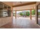 Covered patio area with tiled floors, ceiling fan, and access to the beautifully landscaped backyard at 17951 W Sammy Way, Surprise, AZ 85374
