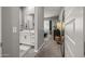 Well-lit bathroom with a modern vanity, a large mirror, and a walk-in shower showcasing contemporary design at 18970 W Desert Hills Dr, Surprise, AZ 85388