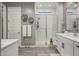 Modern bathroom featuring a glass shower, white cabinets, and stylish decor at 18970 W Desert Hills Dr, Surprise, AZ 85388