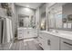 Spacious bathroom with double vanity, large mirrors, and elegant tile flooring at 18970 W Desert Hills Dr, Surprise, AZ 85388
