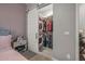 Bedroom walk-in closet featuring a washer and dryer and storage at 18970 W Desert Hills Dr, Surprise, AZ 85388