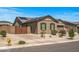 Beautiful single-story home featuring desert landscaping, solar panels, and a gated driveway at 18970 W Desert Hills Dr, Surprise, AZ 85388