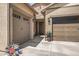Inviting front entry with a two-car garage, a single-car garage, and manicured landscaping at 18970 W Desert Hills Dr, Surprise, AZ 85388