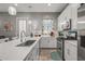 Modern kitchen featuring white cabinets, stainless steel appliances, and a large sink at 18970 W Desert Hills Dr, Surprise, AZ 85388
