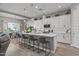 Spacious kitchen features a large center island, white cabinets, pendant lighting, and an adjoining dining area at 18970 W Desert Hills Dr, Surprise, AZ 85388