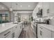 Bright kitchen boasting white cabinets, a large island with a sink, stainless steel appliances, and wood flooring at 18970 W Desert Hills Dr, Surprise, AZ 85388