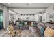 Open-concept living room with spacious seating and a view of the modern kitchen at 18970 W Desert Hills Dr, Surprise, AZ 85388