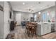 Open-concept living room with kitchen island, wood-look floors, and modern décor at 18970 W Desert Hills Dr, Surprise, AZ 85388