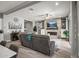 Comfortable living room with a stone fireplace, built-in shelving, and wood flooring, perfect for relaxing and entertaining at 18970 W Desert Hills Dr, Surprise, AZ 85388
