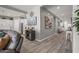 Open-concept living space with modern decor and wood-look tile flooring at 18970 W Desert Hills Dr, Surprise, AZ 85388