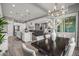 Open concept living space featuring a kitchen, dining area, and living room with abundant natural light and stylish furnishings at 18970 W Desert Hills Dr, Surprise, AZ 85388